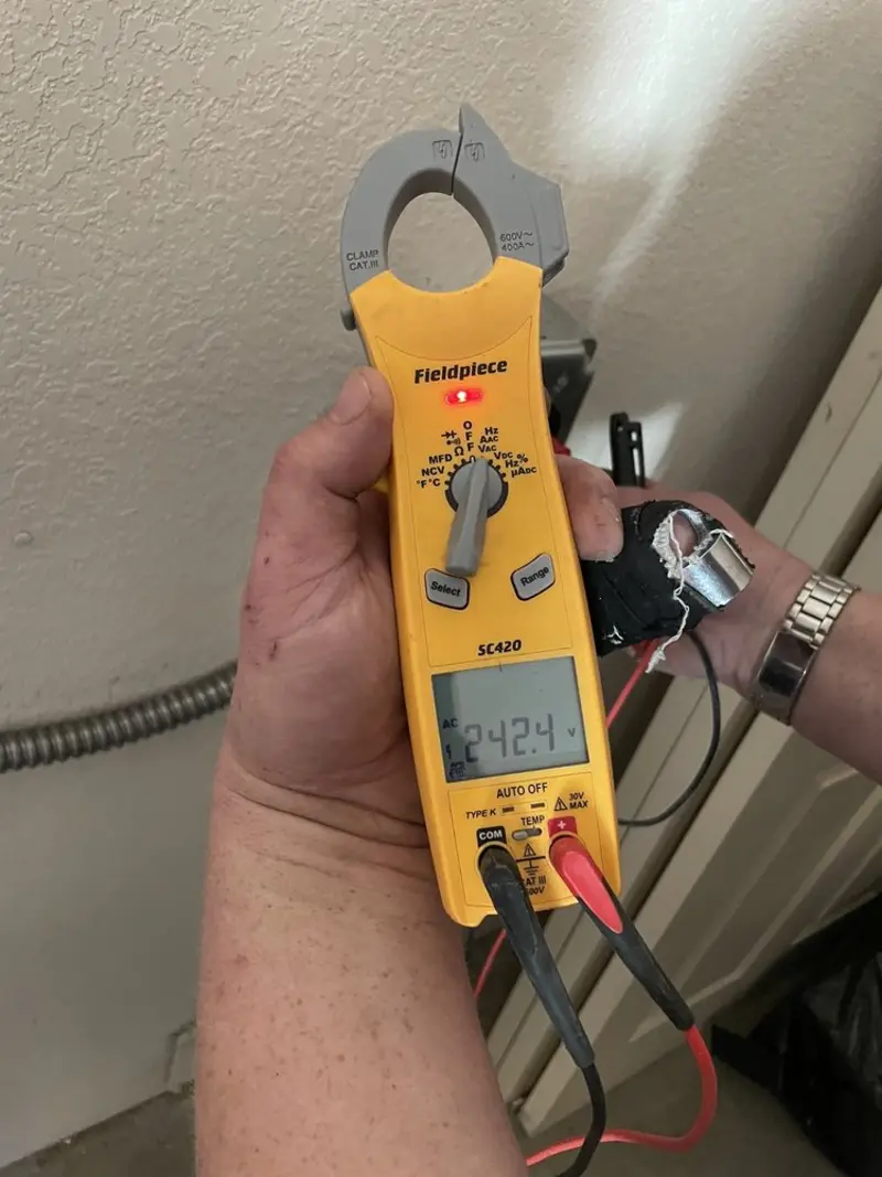 Voltage testing with clamp meter during Outlet Installation in Clarkston Heights-Vineland